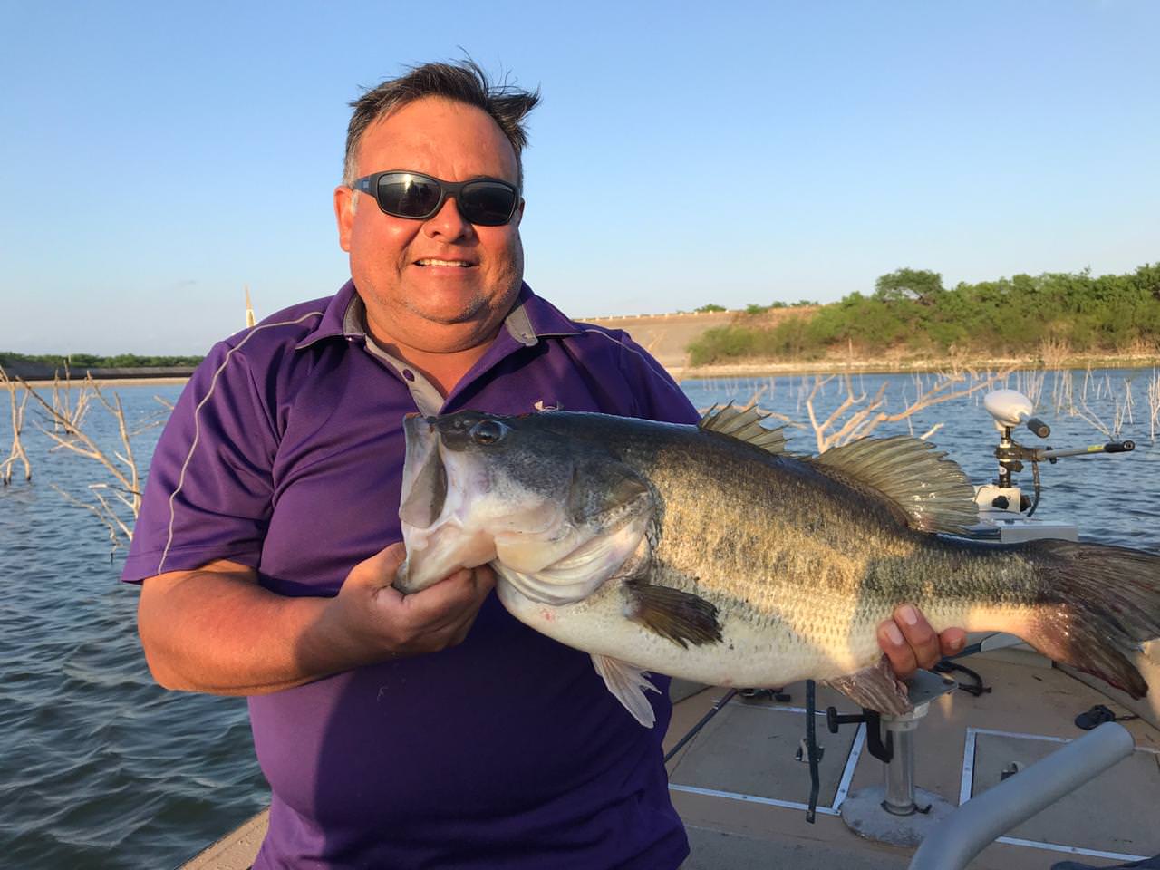 Guide holding a 12-pound Sugar Lake bass